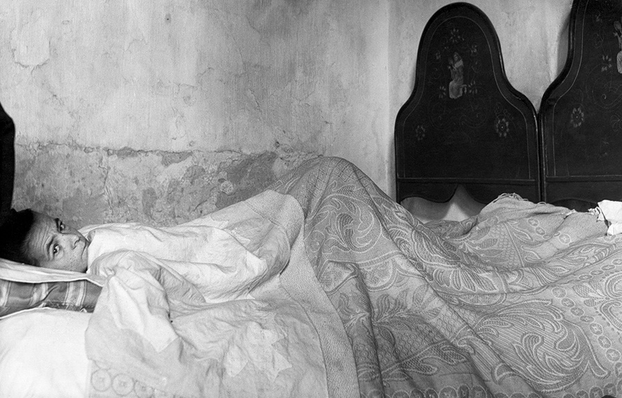 Partinico. Ill woman in bed, 1954